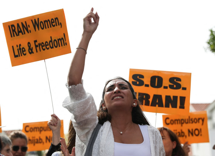 People take part in a protest in front of the Iranian Embassy in support of anti-regime protests in Iran following the death of Mahsa Amini, in Madrid, Spain September 28, 2022.