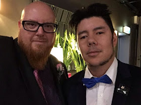 Jason and Adam at Carly and Adam's wedding - wearing suits, looking hot