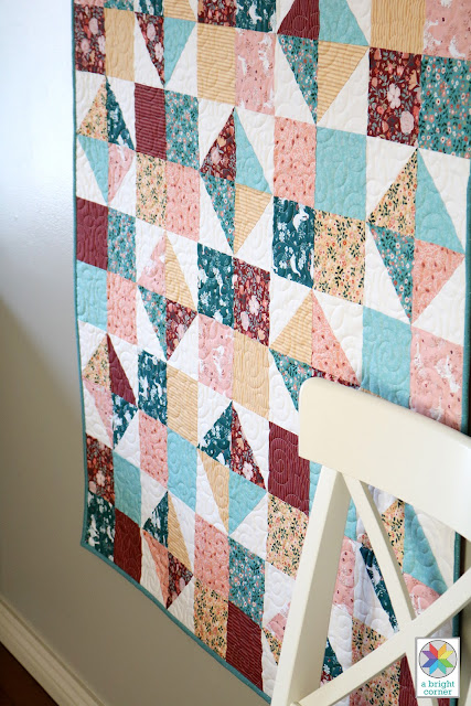 Four Patch Spin quilt pattern by Andy of A Bright Corner - a free download for an easy, fat quarter friendly lap size quilt