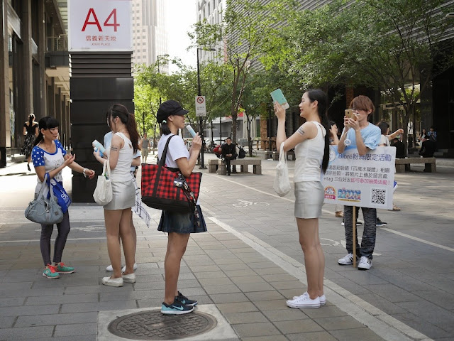 young woman having her photo taken with a Biore lotion