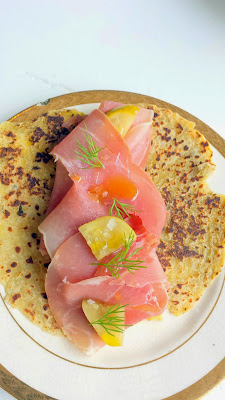 A plate of lefse with ham, brie and tumeni pickles from the menu at Maurice