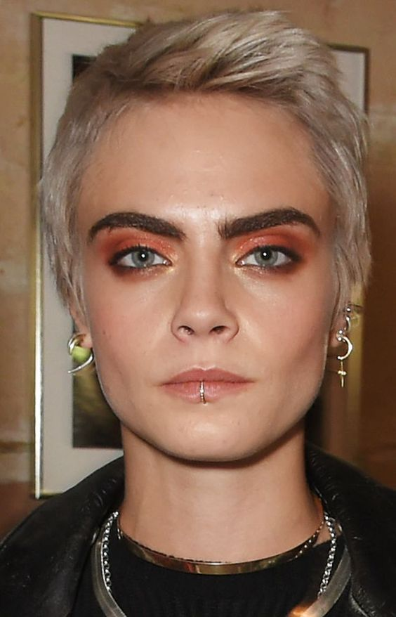 Cara shows of her iconic lip piercing