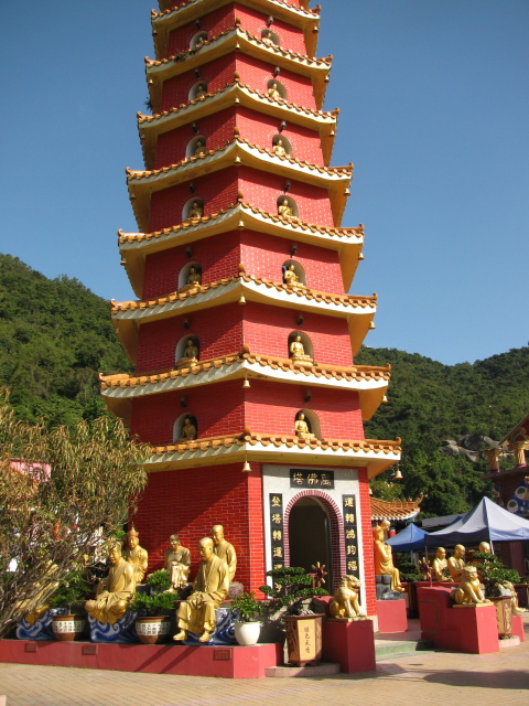 smaller buddhas set in windows in a tall tower