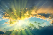 Iridescent clouds occur when rays of sunlight shine through a thin layer of cloud comprised of ice crystals. Stock photo