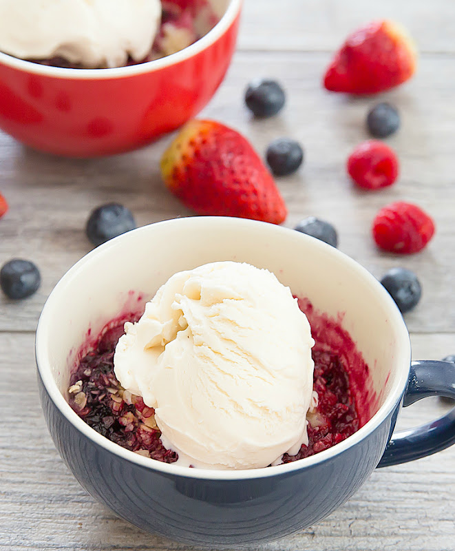 photo of a Berry Cobbler Mug Cake topped with vanilla ice cream