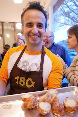 Jose Chesa passing out Xuixo, a pastry that is a bit remisicent of a croissant, stuffed with cream and fried and covered with sugar at 180