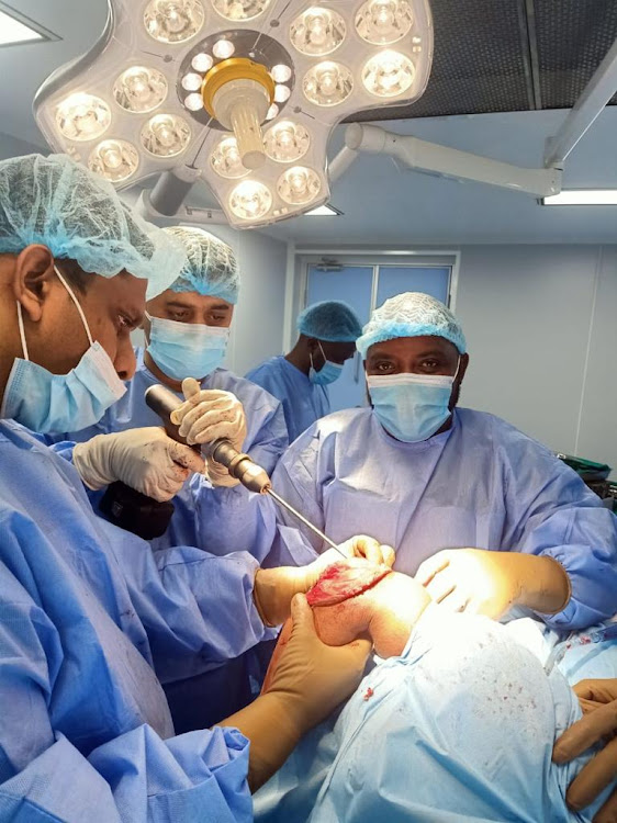 Senior orthopedic consultant Dr Kartikeya Joshi leads a team of surgeons to perform elbow replacement surgery on Samwel Njoroge at the Mediheal Hospital in Nairobi on April 26, 2021