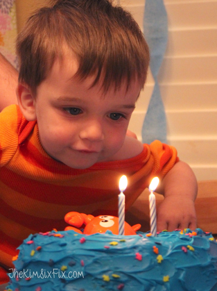 Baby blowing out birthday candles