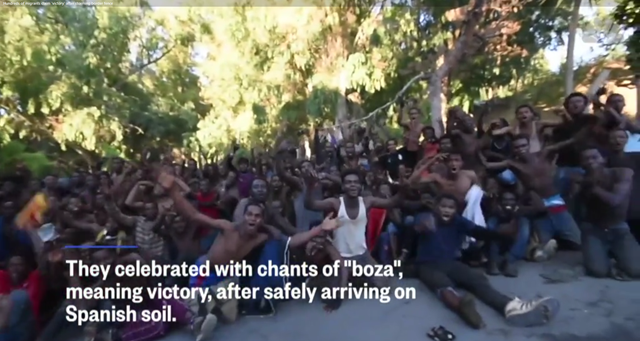 Screenshot from a video showing migrants celebrating after storming border fences separating Spain's North African enclave of Ceuta from Morocco to get into Europe, on 26 July 2018. Photo: NBC News