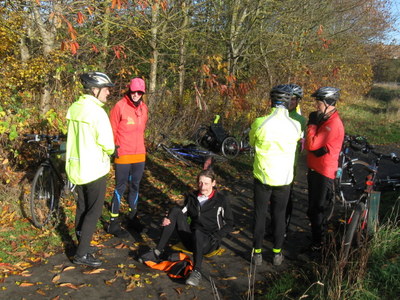 Group stands around fallen cyclist