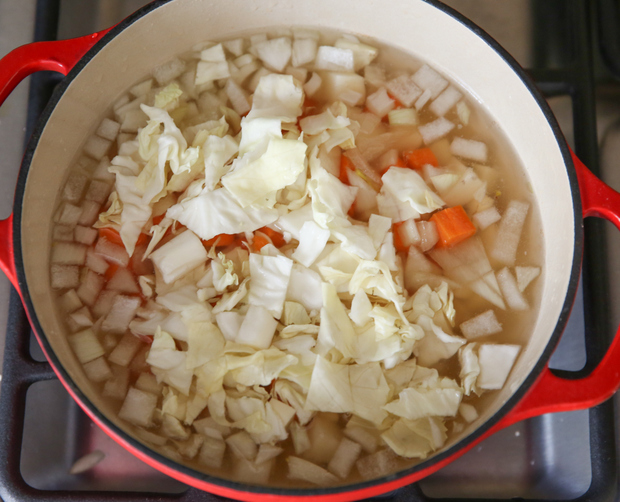 overhead photo of a simmering pot with vegetables