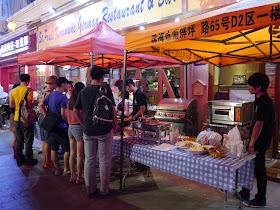 tent selling food and drink outside of the St. Pauli Kommune German Restaurant & Bar in Zhuhai, China.