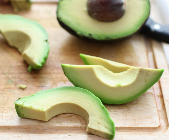 step by step photo showing how thick the avocado slices should be