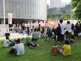 people siting in a grassy area