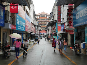 people walking down a narrow street in Changde