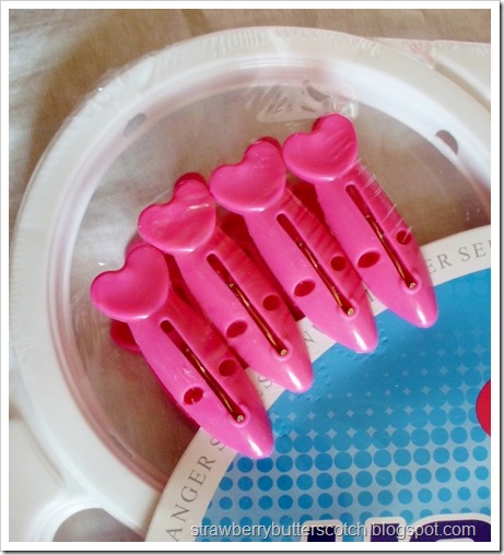 Close up of pink clips on laundry rack