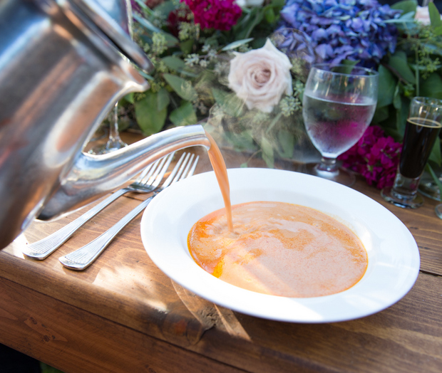 photo of lobster bisque being poured into a bowl