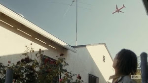 Scene with a plane in the background from episode 3 