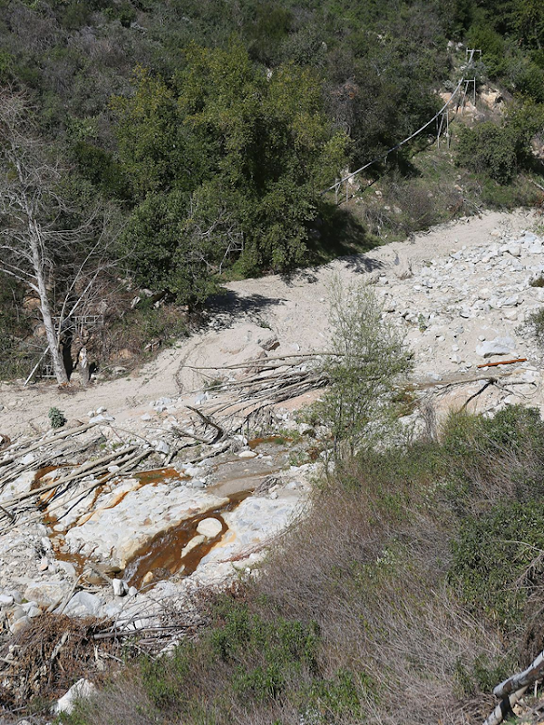 A water pipeline runs alongside Strawberry Creek in the San Bernardino National Forest. The pipe carries water from Arrowhead Springs to be bottled by Nestle. Photo: Jay Calderon / The Desert Sun