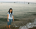 Fialka Grigorova on the beach at Sandy Point State Park, with the Chesapeake Bay Bridge in the background, on the Chesapeake Bay near Annapolis.