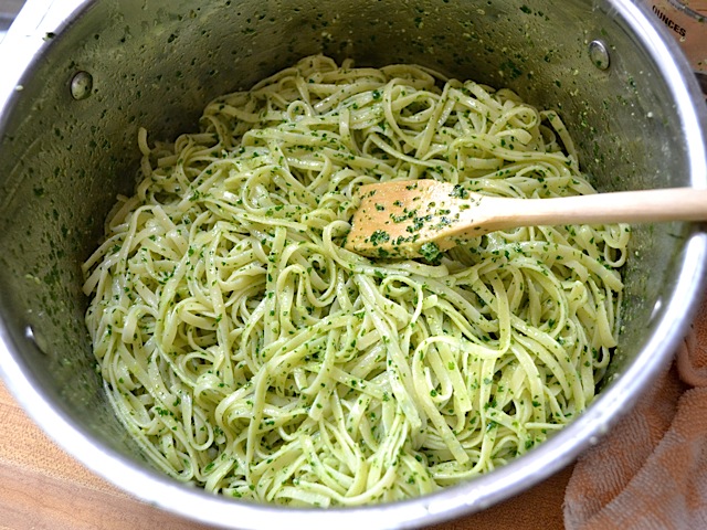 pasta coated in pesto in pot 