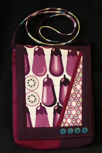 a shoulder bag made of fabric printed with eggplants