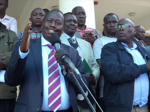 Baringo County Governor Benjamin Cheboi addressing the faithful during fundraiser at AIC Kaptorot in Baringo North Sub-county on Saturday. He was accompanied by the area MP William Cheptumo. The leaders asked professionals to support reelection of seating jubilee leaders in next years 2017 general election saying they needed to complete the initiated projects. PHOTO/ JOSEPH KANGOGO