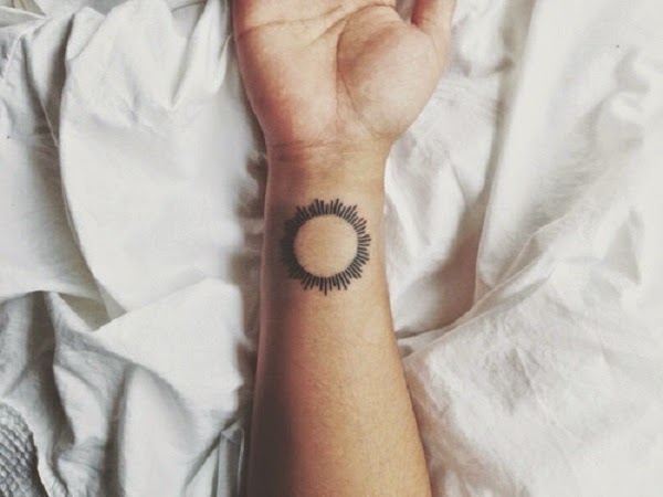 little sun tattoo on the wrist