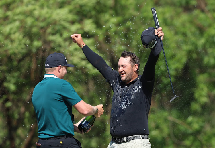 SA’s Thriston Lawrence is sprayed with champagne by Sunshine Tour professional Albert Venter after his victory in the SA Open Championship, December 4 2022. Picture: LUKE WALKER/GETTY IMAGES