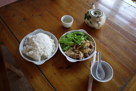 dish of chicken and snow peas next to a large bowl of rice