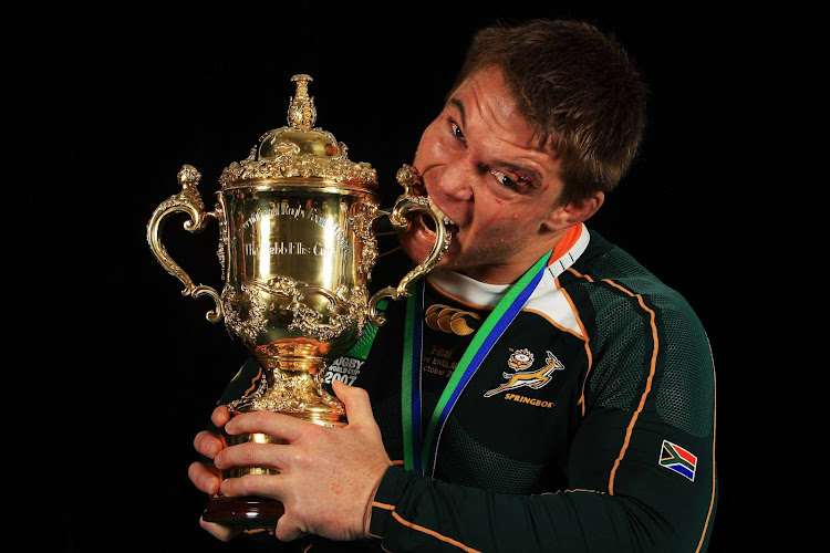 Skipper John Smit bites the trophy after the Springbok victory over England at the 2007 Rugby World Cup in France. Picture: GETTY IMAGES/GALLO IMAGES