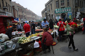 woman selling vegetables at a street market