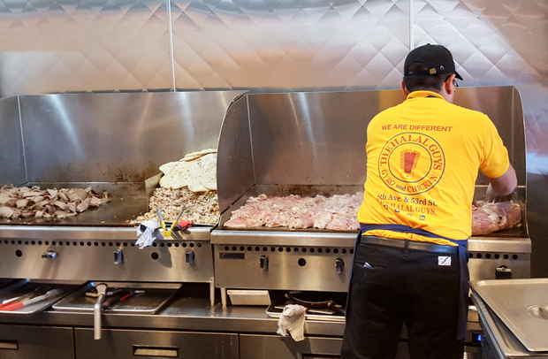 photo of an employee grilling meat