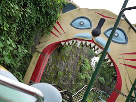 about to go through a giant cat's mouth while riding a roller coaster