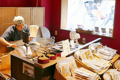 Senbei store where we observed it being made fresh in Higashiyama District. This senbei has been produced since 1864 and is still hand baked the exact same way. These are different in that they utilize broad bean, wheat, flour and an egg.