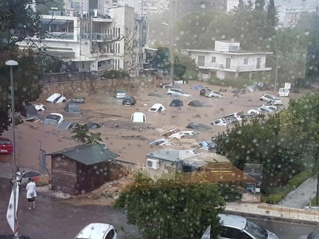 Cars float in floodwater in an open parking area in northern Athens, Thursday, 26 July 2018, after a sudden downpour caused flash floods. Photo: Panagiotis Michalopoylos / AP Photo