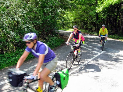 three cyclists riding