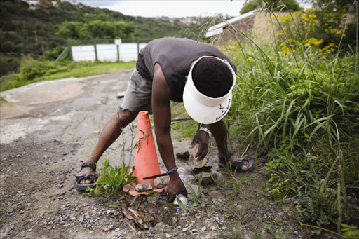 WASTAGE: Residents say water has been flowing freely down this driveway in Nahoon for more than a month Picture: MARK ANDREWS