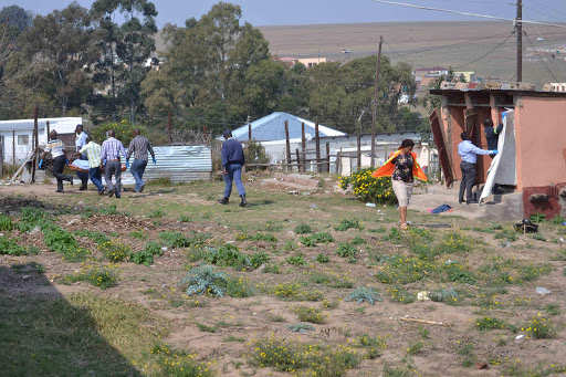 Police investigators and forensic staff remove the body of 24-year old Khanyisa James after her seven year old son discovered her body in a toilet in Old Payne Location. Pictures: LOYISO MPALANTSHANE