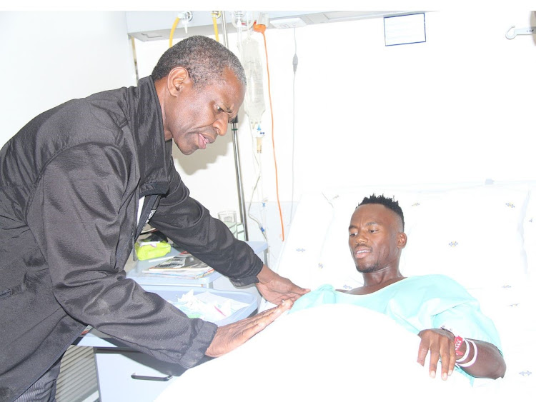 MEC Sibongiseni Dhlomo with triathlete Mhlengi Gwala in hospital, where Gwala is recovering following an attack by unknown assailants. Image: SUPPLIED