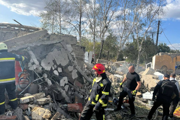 Rescue workers comb the site of a Russian military strike in the village of Hroza in Kharkiv region, Ukraine, on October 5 2023.