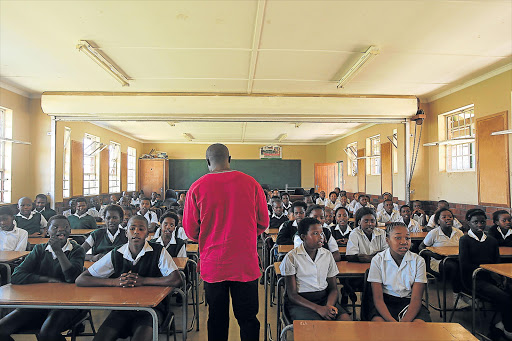 NOT CONDUCIVE: An overcrowded Grade 7 class at Mbekweni Primary School gets the first lesson of the year Picture: SIBONGILE NGALWA