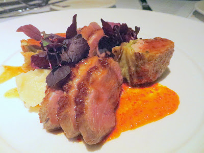 Bluehour entree of Smoked Duck Breast with sweet potato, savoy cabbage, and ginger sausage