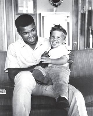 Muhammad Ali with Bob Gomel's son, Corey, on his lap