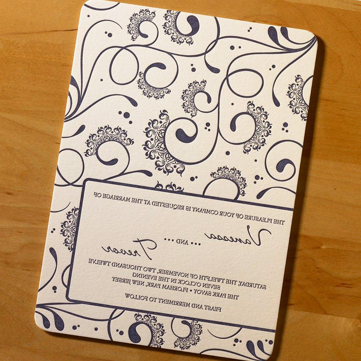 This impressive letterpress wedding invitation features vivacious swirls