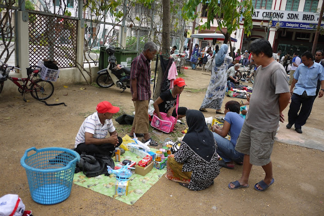 selling items at an outdoor market in George Town, Penang, Malaysia