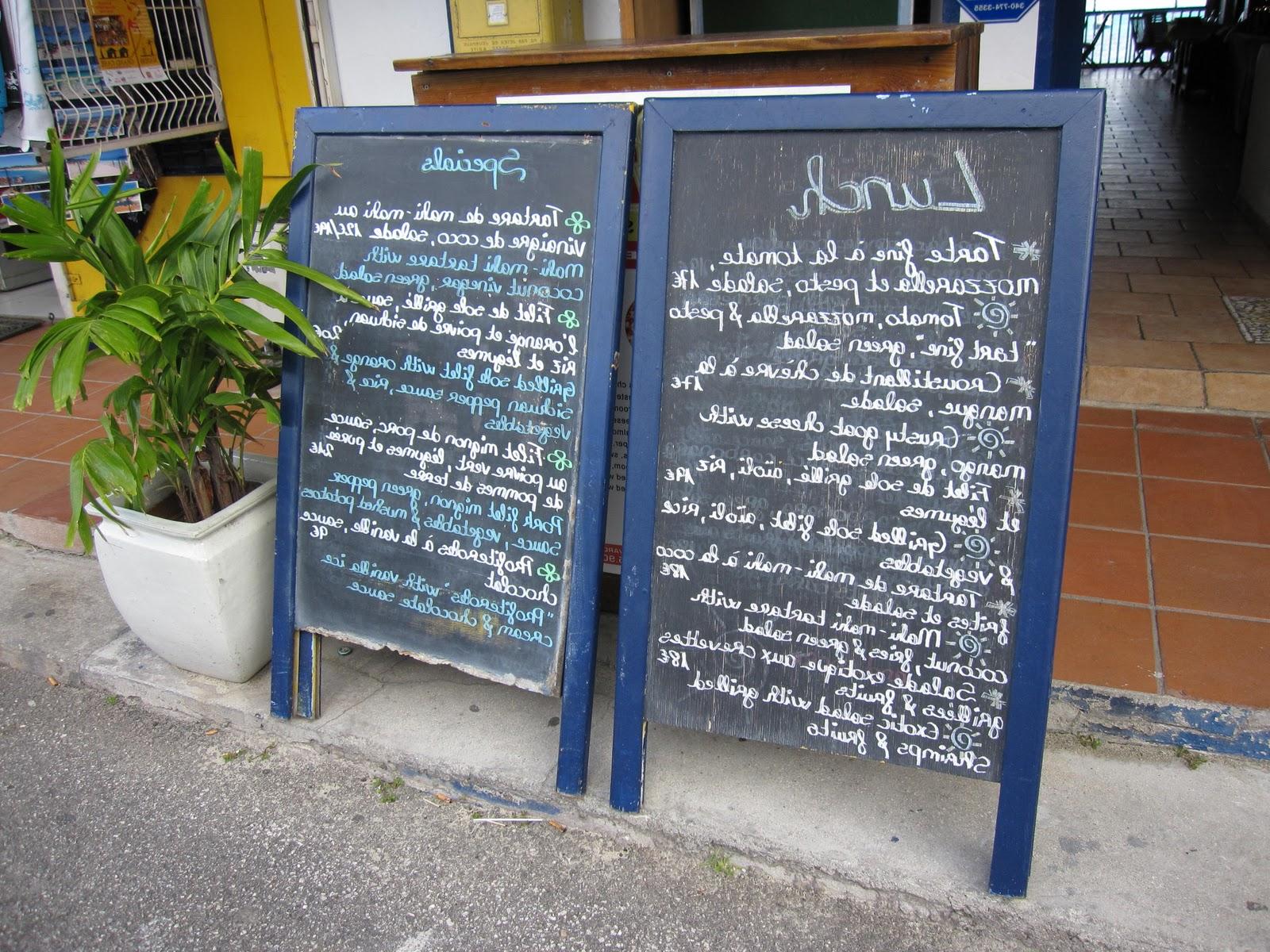 A pair of menu boards outside