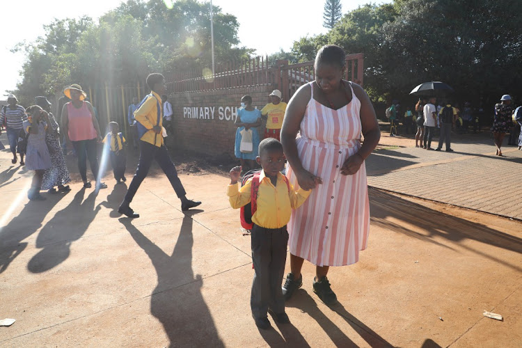 Nonkululeko Magagula with her child Tshepo during the school opening at Tholimfundo Primary School in Protea Glen, Soweto.