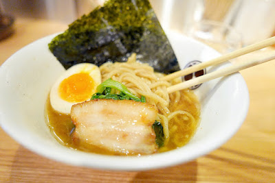 Visiting the Shin Yokohama Ramen Museum - My mini-ramen bowl here is from Muku Zweite in which the soup is boiled for 3 days with pork bone and chicken. The ingredients for the ramen noodles uses durum flour for pasta and flour for pizza which is unique for this ramen shop from Frankfurt, Germany. You can also order German beer and currywurst sausage here in the shop and include as one of your toppings sauerkraut