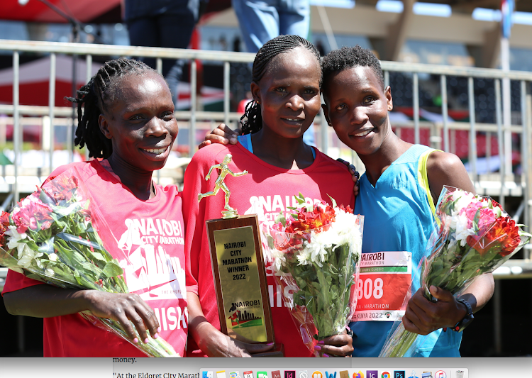 Women's 42km winner Agnes Barasosio (C), second placed, Shyline Jepkorir (R) and Sharon Jemutai.